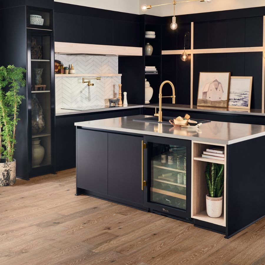 Hardwood flooring in kitchen, black cabinets, white tile backsplash